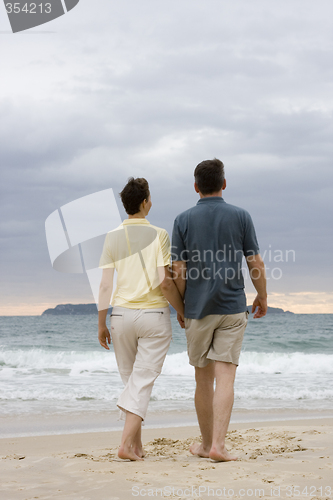 Image of Couple walking on the beach