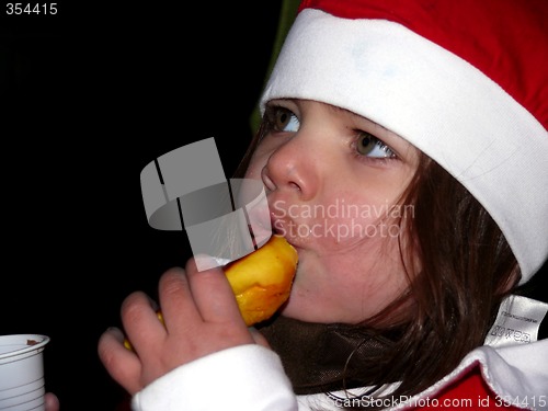 Image of Cristmas girl eating bun!
