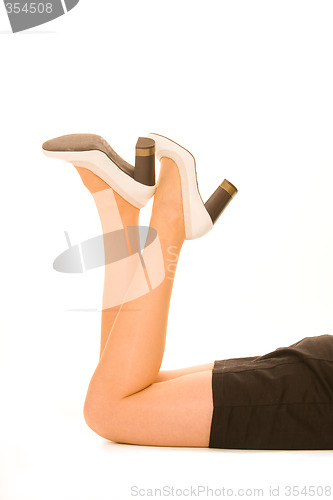 Image of Woman legs with white shoes