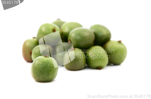 Image of Kiwi berry against heap of green berries