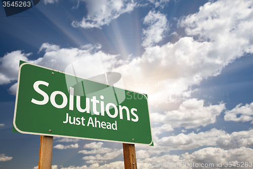 Image of Solutions Green Road Sign Over Clouds