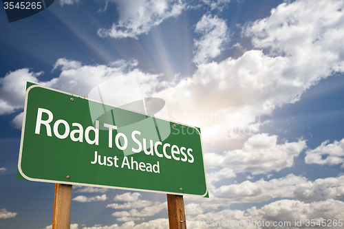 Image of Road To Success Green Road Sign Over Clouds