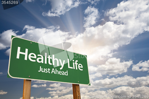 Image of Healthy Life Green Road Sign Over Clouds