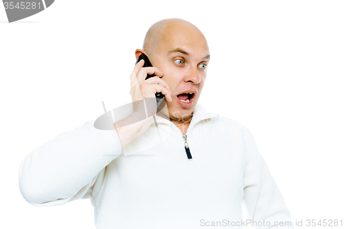 Image of Bald man emotionally communicates by phone. Isolated. Studio
