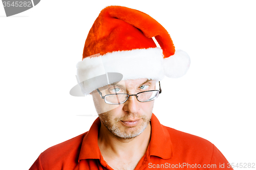 Image of Unshaven slanting eyes Man in Santa hat. Isolated on white. Humo