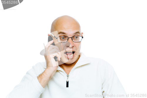 Image of Bald man emotionally communicates by phone. Isolated. Studio