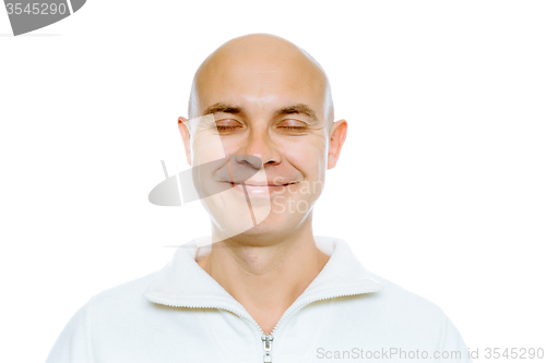 Image of Bald smiling man with his eyes closed. Isolated. Studio