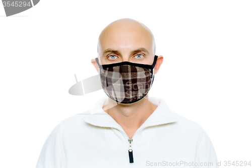 Image of Bald, man in a white jacket and mask. Studio. isolated