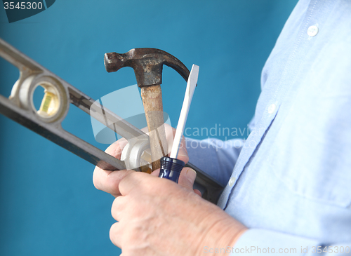 Image of tools in a man's hand