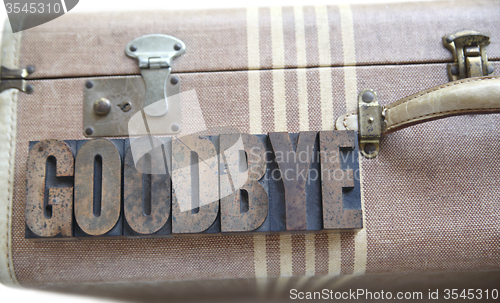 Image of goodbye word on vintage suitcase