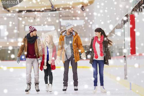 Image of happy friends on skating rink