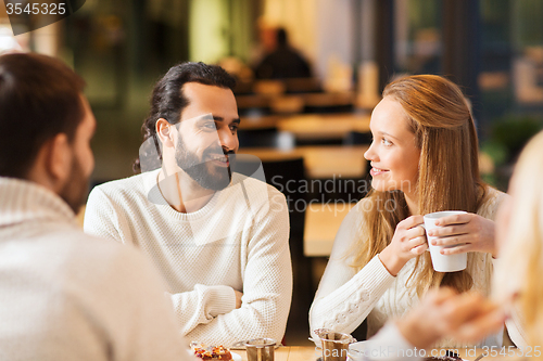 Image of happy couple meeting and drinking tea or coffee