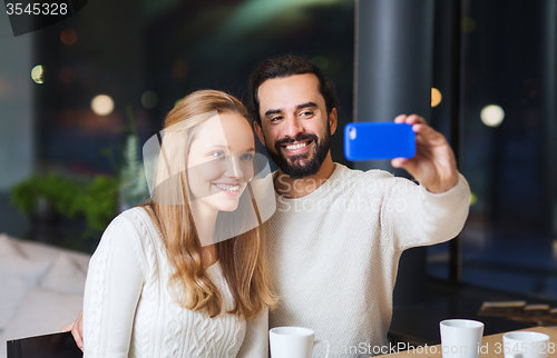 Image of happy couple with tablet pc and coffee at cafe