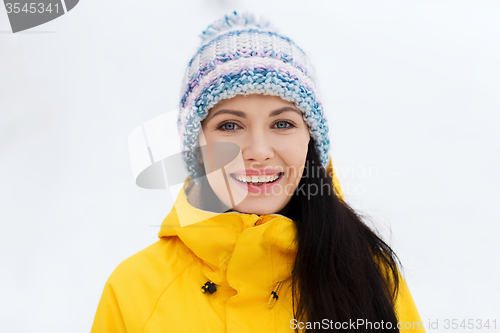 Image of happy young woman in winter clothes outdoors