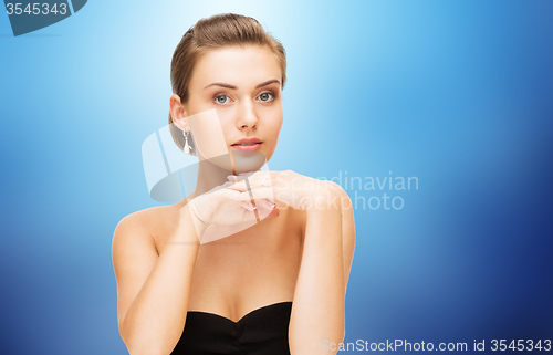 Image of beautiful woman with diamond earrings and bracelet