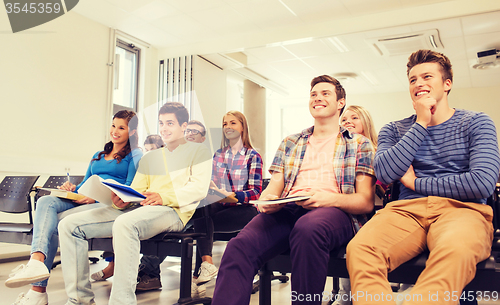 Image of group of smiling students in lecture hall