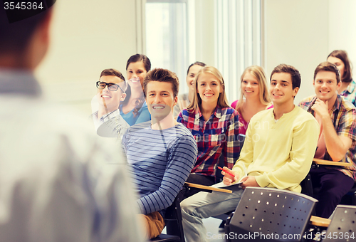 Image of group of students and teacher with notebook