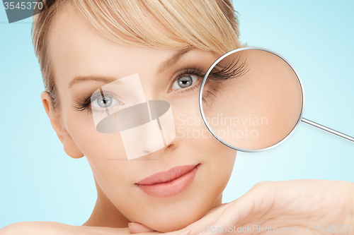 Image of beautiful young woman face over blue background