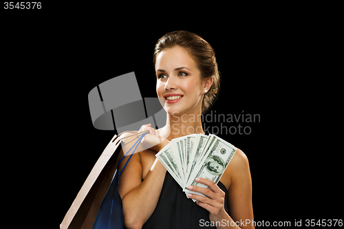 Image of smiling woman in dress with shopping bags