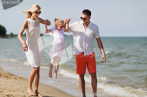 Image of happy family in sunglasses on summer beach