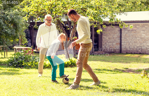 Image of happy family playing football outdoors