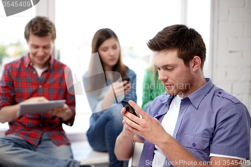 Image of group of students with smartphone at school