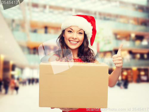 Image of smiling woman in santa helper hat with parcel box