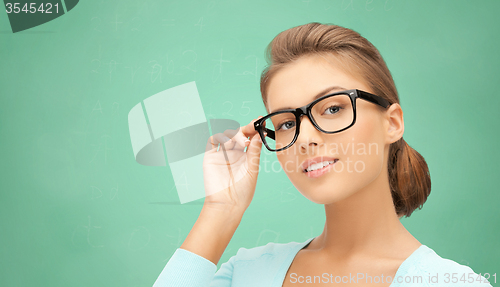 Image of happy teenage student girl or woman in eyeglasses