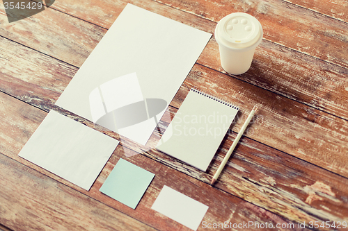 Image of close up of notebook, coffee cup and papers