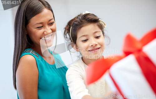 Image of happy mother and child with gift box