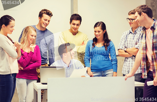 Image of group of students and teacher with laptop