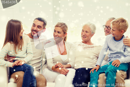 Image of happy family sitting on couch at home