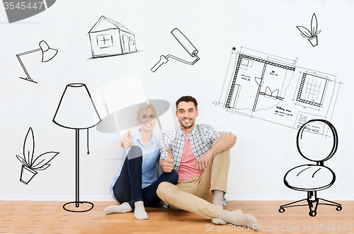 Image of happy couple showing thumbs up at new home