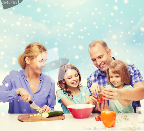 Image of happy family with two kids making dinner at home