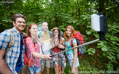 Image of friends with backpack taking selfie by smartphone