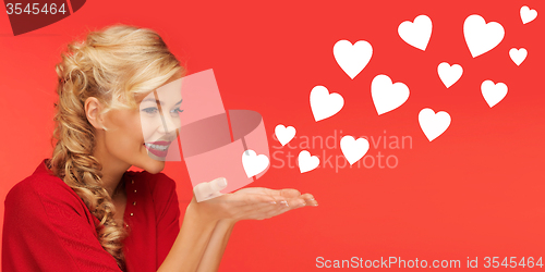 Image of woman sending heart shapes from palms of her hands