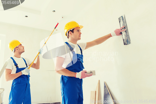 Image of group of builders with tools indoors