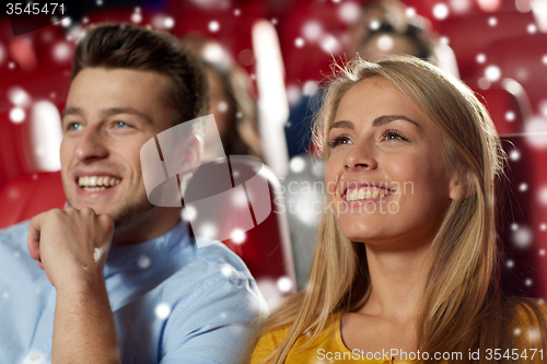 Image of happy couple watching movie in theater