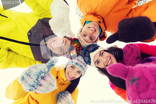 Image of happy friends in winter clothes outdoors