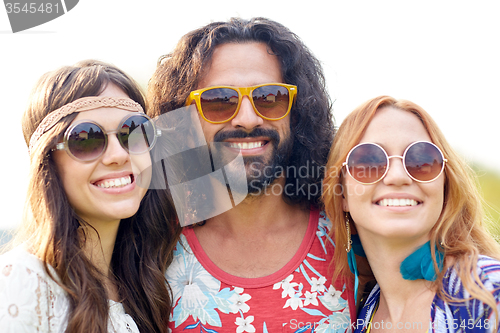 Image of smiling young hippie friends outdoors