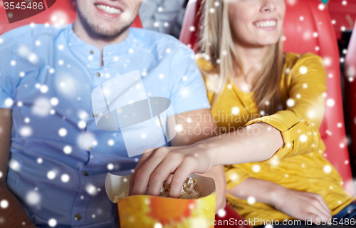 Image of happy couple with popcorn in movie theater
