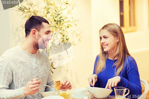 Image of happy couple meeting and having dinner at cafe