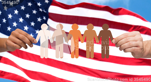 Image of hands with people pictogram over american flag