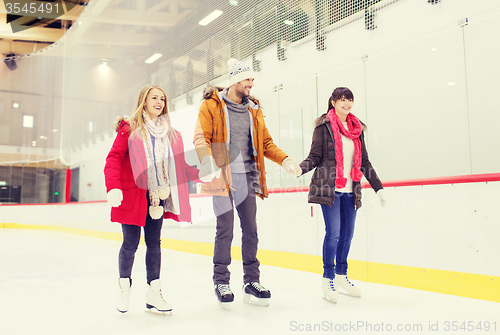 Image of happy friends on skating rink