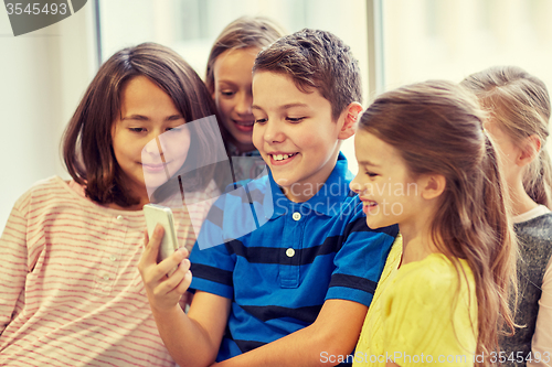 Image of group of school kids taking selfie with smartphone