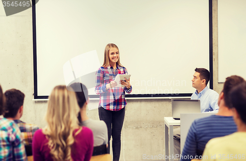 Image of group of smiling students and teacher in classroom