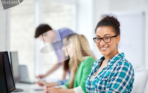 Image of happy high school students in computer class