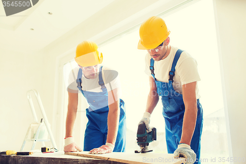 Image of group of builders with tools indoors