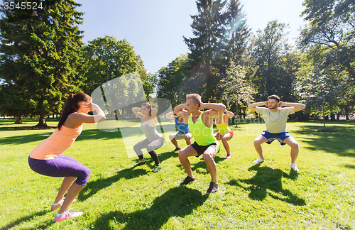 Image of group of happy friends exercising outdoors