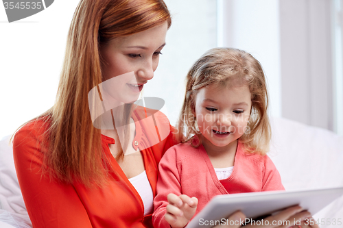 Image of happy mother and daughter with tablet pc computer
